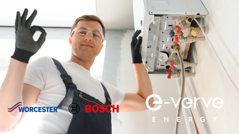 gas safe registered engineer installing a worcester bosch white boiler giving an ok hand symbol